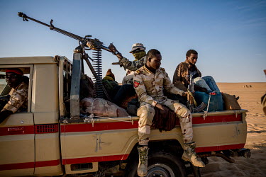 Aghali Ahmet, a young migrant, sits in the back of an army truck after being picked up by the military in the Tenere desert between Amzergem and the 'Well of Hope'. He had been waiting for days after...