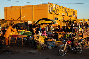 Market traders sell their goods outside the bus station in Agadez.