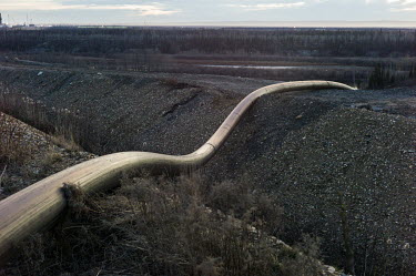 A temporary water intake pipe, leads from the Athabasca River to an oil sands extraction facility. The process of separating crude from raw oil sands bitumen consumes three barrels of fresh water for...