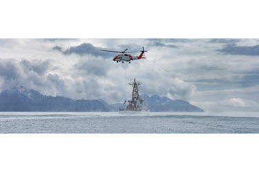 The coastguard boat Mustang, whose base is at Seward, conducts a search and rescue exercise with a helicopter, USCG Jay Haw, in Prince William Sound.