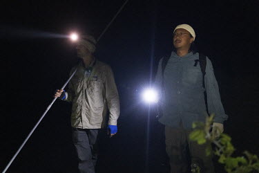 Researchers Sam Banks (left) from the Charles Darwin University and Yusuke Fukuda (right) from the Australian National University search for crocodiles in swamp lands outside Lospalos. The men use the...