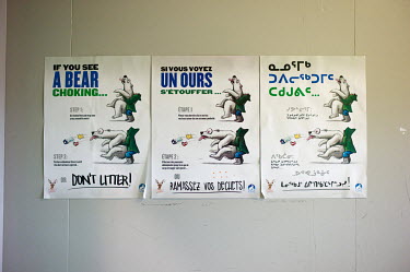 A humorous poster that encourages local residents not to litter is posted in English, French and the traditional Inuit language of Inuktitut, at the Arctic Winter Games Arena.