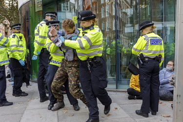 A man taking part in non-violent direct action during Extinction Rebellion protests is arrested outside the DEFRA offices on Marsham Street in Westminster.