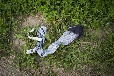A dress tie lies on the ground at an illegal crossing point, popular with asylum seekers, on the Canada/US border.