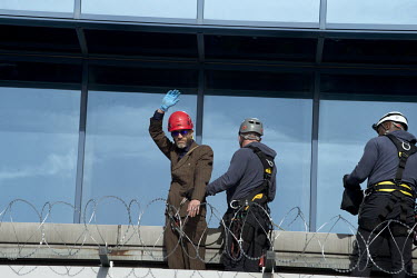 A protestor who scaled the building at London City Airport during a non-violent direct action Extinction Rebellion protest at London City Airport.