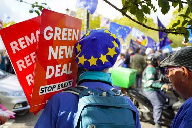 An Anti-Brexit protester on the Peoples' Vote March demonstration walks to the Houses of Parliament in Westminster, holding a sign promoting a 'Green Newe Deal'. An estimated 1 million people took par...