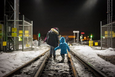 Two asylum seekers, a woman and young girl, cross the Canadian border.