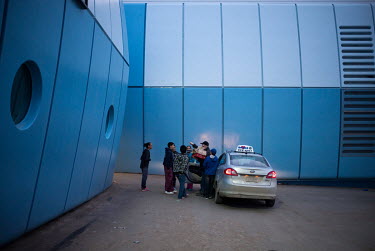 Young football (soccer) players crowd around a driver as he delivers fast food to the Inuksuk high school15. Due to lack of funds, all the visiting teams in the tournament had to sleep at the local hi...