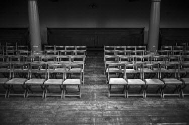 Rows of chairs lined up in a Mennonite church beside the Singel canal in central Amsterdam. It is one of the first Mennonite churches in the world, constructed secretly, within a courtyard, during the...