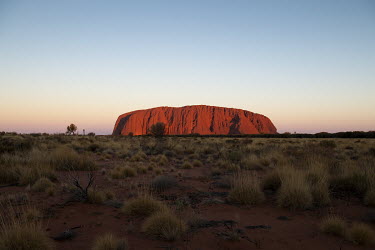 Uluru at sunset.   Tourists are rushing to climb world heritage-listed Monolith, Uluru in Australia's central desert before a ban on climbers takes effect. The date of the closure, 26 October 2019,...