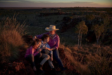 Jane Sale, who runs the Yougawalla cattle station with her husband, and her children Matilda and Angus, watching the sunset on a ridge not far from the Yougawalla homestead.