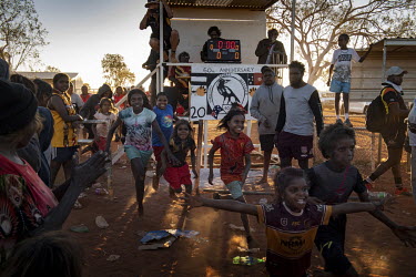 Led by children, the Lajamanu women's Australian Rules Football team team race on to the oval for the women's grandfinal at the Yuendumu Football Carnival. The match was played between Lajamanu and Sa...