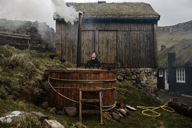 Oluf Durhuus (18) preparing an exterior hot tub.