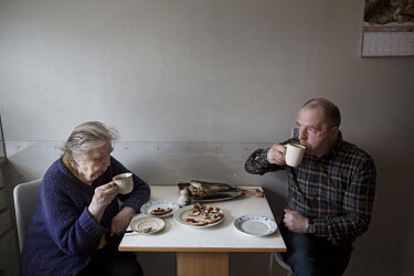 Andrias Justesen (56) eating lunch with his mother Olova (82). Andrias is one of many unmarried fishermen. He doubts he will ever find a girlfriend. He lives together with his mother in the very north...