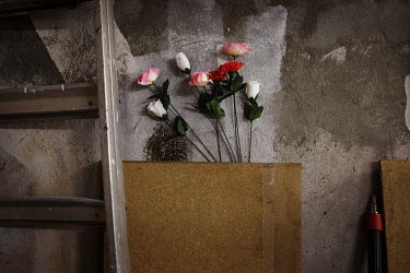 Plastic flowers decorate a basement workshop.