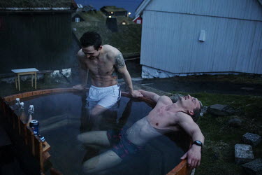 Rogni (26) and Odin (25) take a hot tub late at night. They are visiting a friend who is working as a tour guide during summer.
