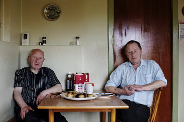 Brothers Klaemint (72) and Nicodemus (69) having dinner in their home in Sand, on the island Sandoy. They are unmarried and live together in the house where they grew up. Klaemint is still a fisherman...