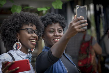 Two women take a selfie during 'Hairitage Chronicles. A festival for the Natural Hair Community'.