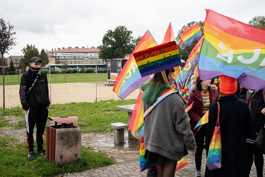 A youth watches as participants in a LGBT pride march gather in a park. The march itself saw a strong police presence to prevent violence before forth coming parliamentary elections.