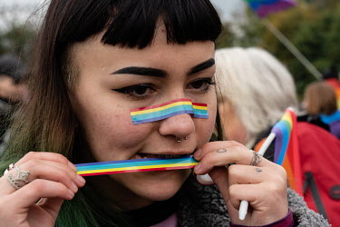 Julia attaches rainbow tape to her face as participants in a LGBT pride march gather in a park. The march itself saw a strong police presence to prevent violence before forth coming parliamentary elec...