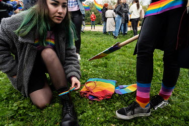 Julia attaches rainbow tape to her boots as participants in a LGBT pride march gather in a park. The march itself saw a strong police presence to prevent violence before forth coming parliamentary ele...