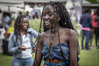 A model shows off her extensions, adorned with gold jewellery, at 'Hairitage Chronicles. A festival for the Natural Hair Community'.