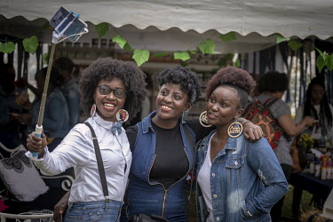 Three women take a selfie during 'Hairitage Chronicles. A festival for the Natural Hair Community'.