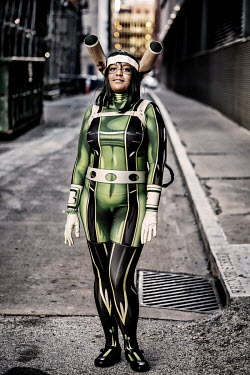 A woman at a Cosplay Tekko event in character as: Tsuyu Asui.