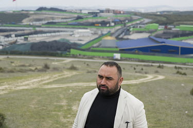 Ismail Sami, a local worker who runs a environmental NGO, stands in front of the town's coal processing centre which dominates one of the hills of Dilovasi.