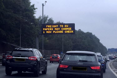 A sign on the motorway warns 'Freight To EU Papers May Change 1 November Please Check'.