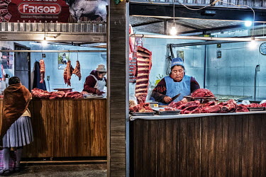 A female butcher at work in hygienic quarter of a meat market.
