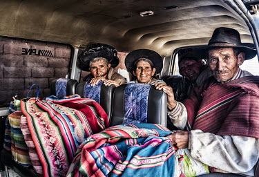 Indigenous Indians wait with their shopping in a minibus to go home.