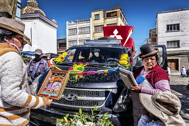 A group of Indigenous Indians bring their new car to the cathedral for a 'car blessing'. They decorate the car with plastic flowers, flags and offering of alcohol and ask the Virgin Mary for protectio...