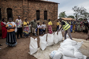 A team from the Catholic charity Caritas distributes food supplies to people affected by Ebola outside a church in the town of Marabo.