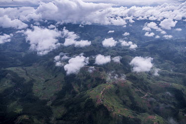 An aerial view of North Kivu where small villages are sited along the region's mountain ridges and fields spread down the hillsides to the valley floors.