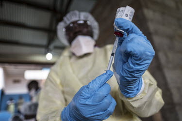 A health worker, at the general hospital in Mambasa, prepares to give a patient an injection containing the vaccine for Ebola.