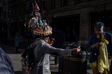 Chito Salarza Grant, with his self-made anti-Brexit hat, takes a selfie with demonstrators marching from Hyde Park to Parliament Square, Westminster, during a 'People's Vote' rally.