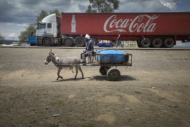A water seller rides his donkey-pulled water tanker, to a customer's house. The man has had several donkeys stolen. Their value has increased in recent years as the demand from China for their skins h...