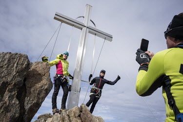 Alpinists are posing for a picture on the summit of Wildspitze, the highest peak of Austrian Tirol, at 3774 metres.