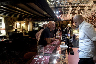 Clifford (55, left) speaks to a barman in the Otter public house, giving him his opinions on Brexit.