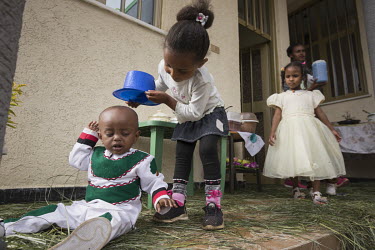 Children playing at a birthday party where the birthday boy is dressed in the colours of the Oromo flag.