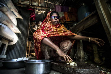 Jahanara Begum (35) prepares a meal in her home in Narsingdhi. Both Begum and her husband, Jashim Uddim, have been blind since childhood.