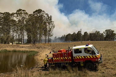 A New South Wales (NSW) Rural Fire Service (RFS) fire engine refills with water from a small dam. Weather conditions in New South Wales (NSW) have made circumstances ideal to spread catastrophic fires...