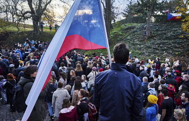 A man carries a Czech national flag during a recreation of the 17 November 1989 march from Albertov to Avenue of the Nation (Narodni trida) during the 30th anniversary of Velvet Revolution.