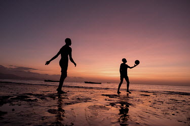 Young men, all of whom said they dreamed of migrating to Mayotte, play football in the evening on the beach.