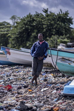 A fisherman and former people smuggler, on the rubbish-covered beach.