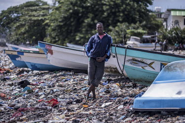 A fisherman and former people smuggler, on the rubbish-covered beach.