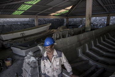 A worker at a 'kwassa kwassa' (a fast fishing boat used to smuggle people from Comoros to Mayotte) factory in Ouani. 'Kwassa kwassas' have become notorious for sinking in the strip of water between Ma...