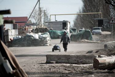 A civilian walks through a checkpoint on the Ukrainian side of the front line.
