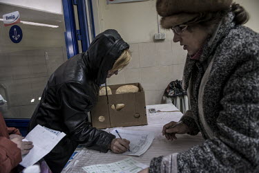 Residents of Debaltseve queue up to receive bread distributed by a Russian charity.